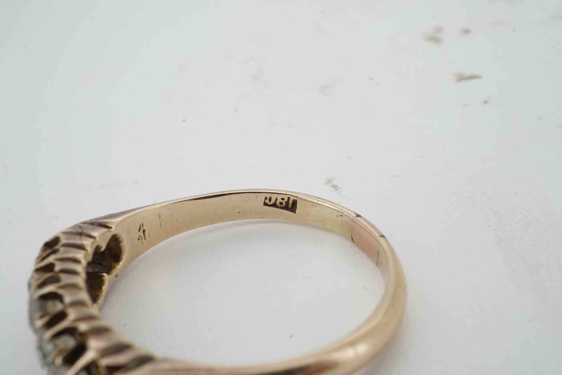 A diamond ring, early 20th century, pavé-set to the front with two rows of cushion-shaped diamonds totalling approximately 0.40 carats, mounted in gold, size O, gross weight approximately 3.5 grams